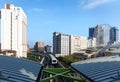 View of a train traveling on elevated tracks of Taipei Metro System between office towers under blue clear sky Royalty Free Stock Photo