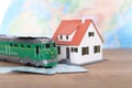 The train ticket home and the little green train and the little house Royalty Free Stock Photo