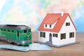 The train ticket home and the little green train and the little house Royalty Free Stock Photo