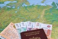 The train ticket, money and the Russian passport lie on a map of Russia