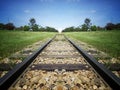 Train track to sky on green grass wood field