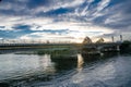 Train track bridge crossing a canal with dramatic cloudy sky in Rural area of Australia. Royalty Free Stock Photo