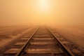 A train track cuts through the barren desert, surrounded by sand, under a clear blue sky, A long stretch of railroad tracks Royalty Free Stock Photo