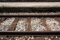 Train track with platform and red grass on them Royalty Free Stock Photo