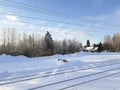 Train tracks and electrical wiring covered in snow. Snowy landscape under blue sky. Nordic winter landscape Royalty Free Stock Photo