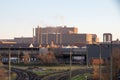 Train tracks going separate ways with a factory in the background Royalty Free Stock Photo