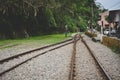 Train tracks on gravel, two of railways tracks merge in a rural scene background, concept of journey Royalty Free Stock Photo