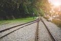 Train tracks on gravel, two of railways tracks merge in a rural scene background, concept of journey Royalty Free Stock Photo