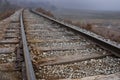 Train tracks leading around a curve and off into the fog Royalty Free Stock Photo