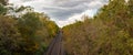 train tracks in the middle of the forest in autumn Royalty Free Stock Photo