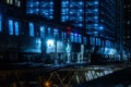 Train on the tracks at night, illuminated by a single red light