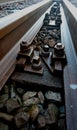 Close-up of railroad bolts with old wooden pads with blurred background Royalty Free Stock Photo