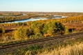 A train tracks run through a field of trees and grass Royalty Free Stock Photo