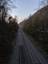 Train tracks through the valley at nightfall Royalty Free Stock Photo