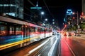a train traveling down a city street at night