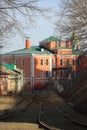 A train traveling down train tracks near a building Royalty Free Stock Photo