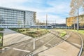 a train traveling down the tracks near a building Royalty Free Stock Photo