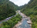 a train is traveling on the track near a forest area, Karangahake Gorge, New Zealand Royalty Free Stock Photo