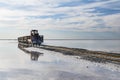 train travels from water. Mined salt in Lake Burlin. Altai. Russia. Bursolith. Old train rides on the railway laid in the water