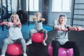 Joyful retired ladies lifting dumbbells at gym Royalty Free Stock Photo