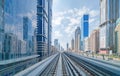 Train view on railway in Dubai Downtown at financial district, skyscraper buildings in urban city, UAE. Transportation for