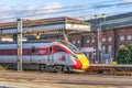A train waits at the end of platform under a canopy and beside a location sign Royalty Free Stock Photo