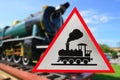 Train warning sign with blurry colored locomotive