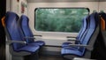 Train window with blurred landscape and empty seats. Royalty Free Stock Photo