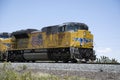 Train with yellow electric locomotive through California