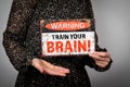 Train Your Brain. Warning sign with text