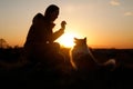 Train your pet at sunset. The friendship between owner and dog. Royalty Free Stock Photo