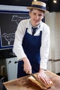 Trainee Butcher Preparing Sirloin Steak