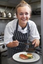 Trainee Chef Working In Restaurant Kitchen Royalty Free Stock Photo