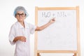 Trainee in chemistry class shows at the formulas on a blackboard Royalty Free Stock Photo