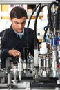 Trainee Engineer Working On Machinery In Factory