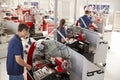 Trainee engineers operating equipment in a small factory Royalty Free Stock Photo