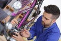 Trainee mechanic working on bicycle Royalty Free Stock Photo