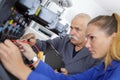 Trainee technician repairing printer with help teacher Royalty Free Stock Photo