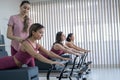 A trainer adjusts women on a reformer. Royalty Free Stock Photo
