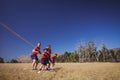 Trainer assisting kids in tug of war during obstacle course training Royalty Free Stock Photo