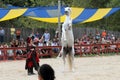 A trainer dressed as medieval lady demonstrates horse skills