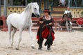 Trainer dressed as medieval lady demonstrates horse skills