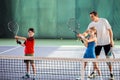 Trainer explaining children how to play tennis Royalty Free Stock Photo