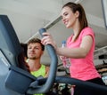 Trainer explaining how to use training machine Royalty Free Stock Photo