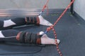 Trainer fasten ropes fixators sportsman legs prepare for myofascial stretching.