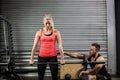Trainer helping woman with lifting barbell Royalty Free Stock Photo