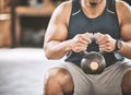 Trainer holding heavy kettlebell in the gym cropped. Hands of a muscular athlete building arm muscle with weights