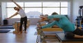 Trainer instructing group of senior women in performing yoga 4k