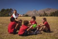 Trainer instructing kids while exercising in the boot camp