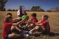 Trainer instructing kids while exercising in the boot camp Royalty Free Stock Photo